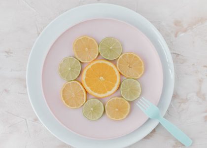 Top view of citrus slices on ceramic plates, showcasing lime and orange artistry.