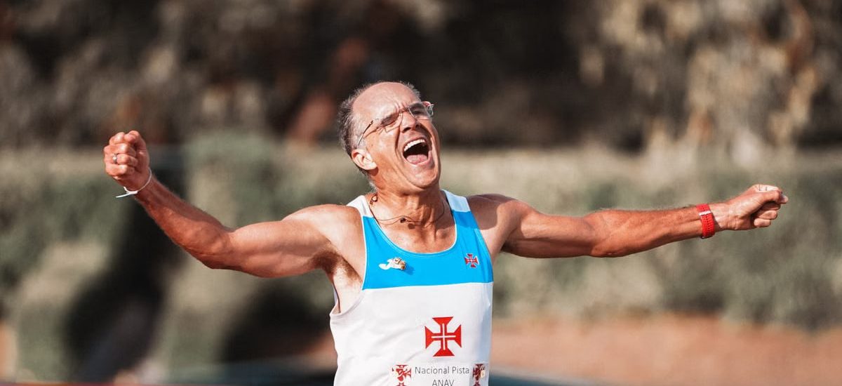 Glad senior male runner with arms outstretched and mouth opened rejoicing success in running competition